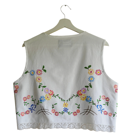 Handmade vest, with flower embroidery from a sustainable fashion brand. Made from recycled materials.