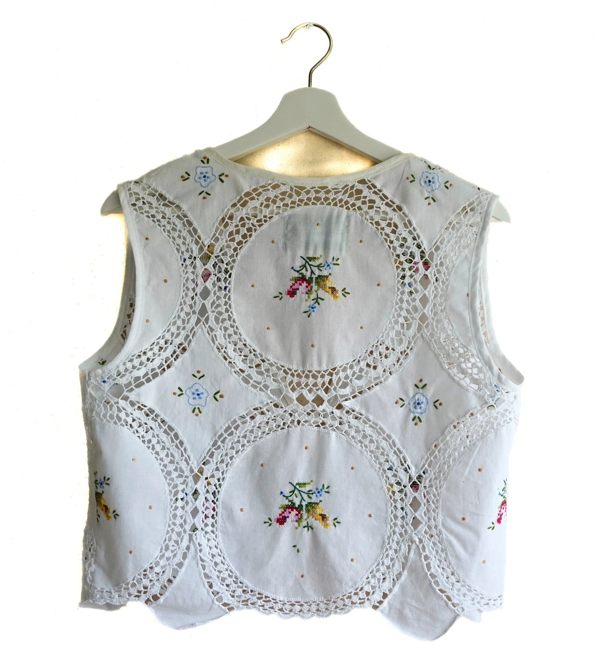 Handmade vest, with flower embroidery from a sustainable fashion brand. Made from recycled materials.