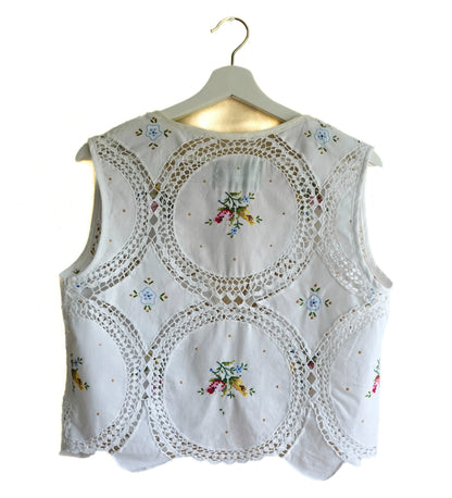 Handmade vest, with flower embroidery from a sustainable fashion brand. Made from recycled materials.